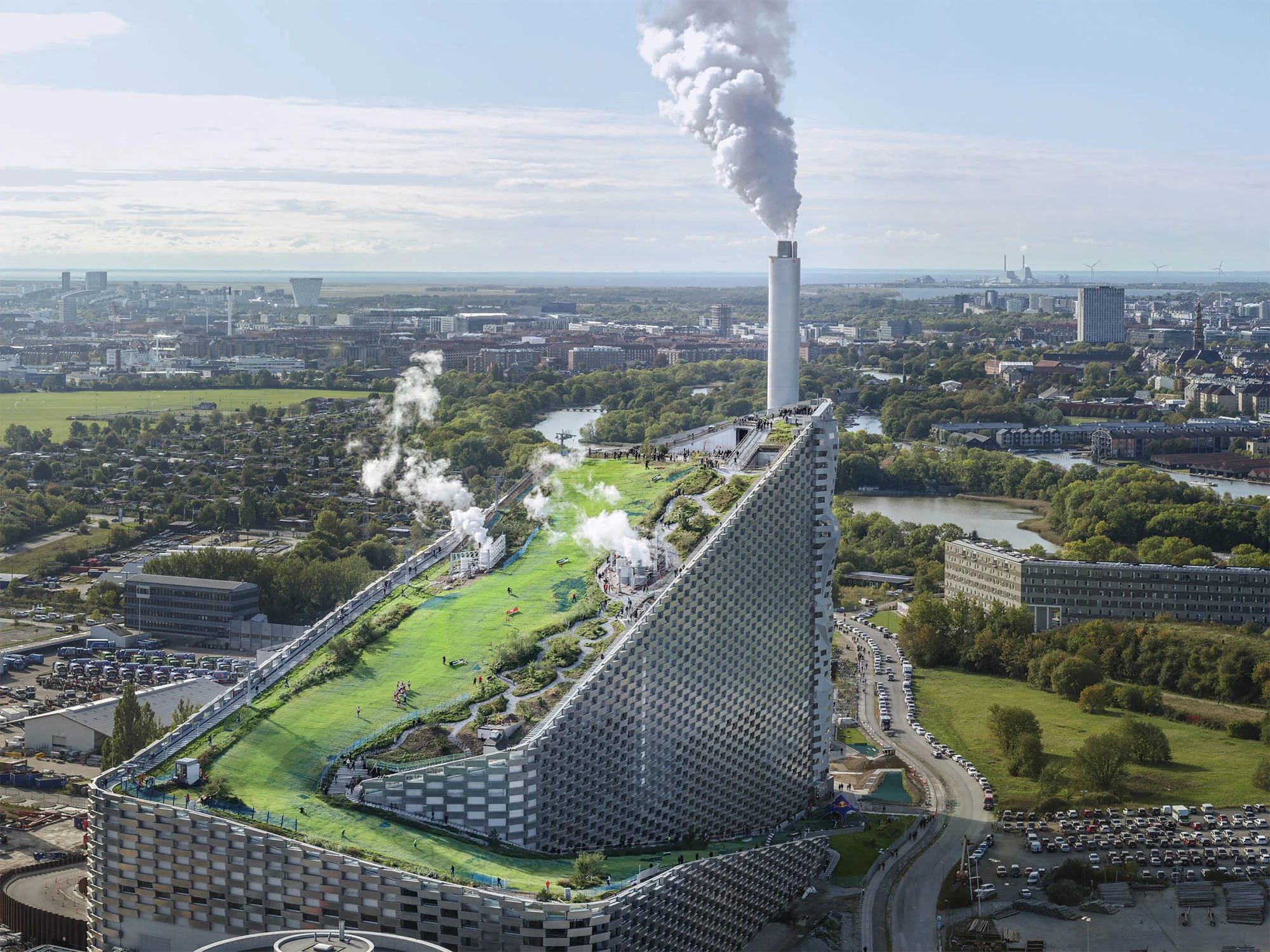 Aerial view of Amager Bakke waste-to-energy plant, Copenhagen, Denmark. Designed by Bjarke Ingels, Amager Bakke claims to be the world's cleanest incinerator, dealing with 70 tonnes of waste coming from Denmark, Germany and Britain every hour, and providing hot water to 120'000 households. Being so close to the centre of the city that it can be seen from the Queen's window, it doubles as a public space. On top of Amager Bakke's massive architecture a ski slope and a hiking track attracts people from the city, offering a different perspective on industrial plants and energy production facilities.